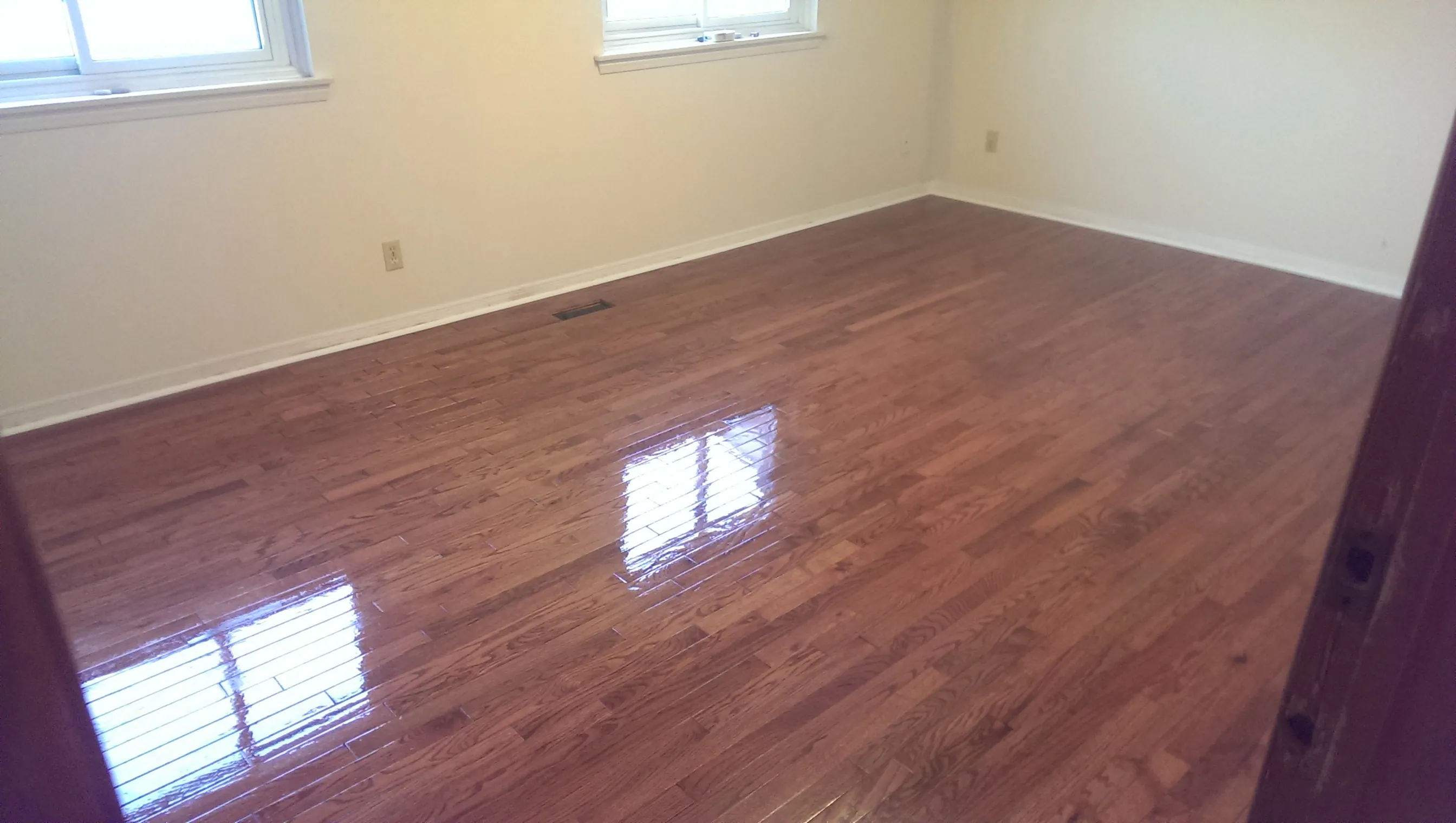 Professional hardwood floor refinishing — glossy finished hardwood in Markham home